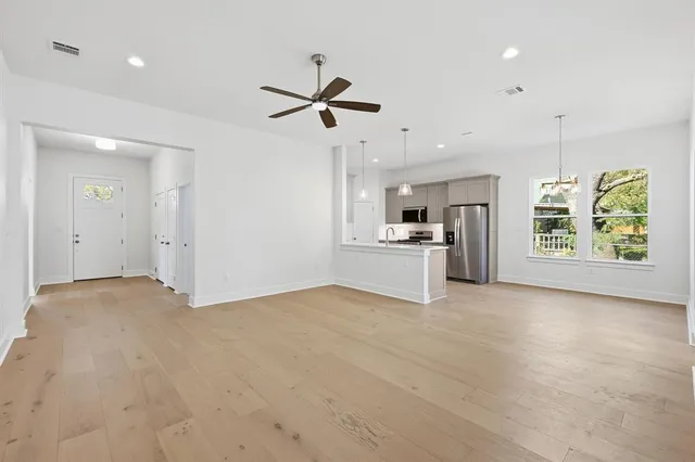 a view of a kitchen with a sink refrigerator and window