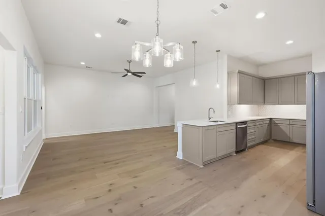 an empty room with a ceiling fan and carpet