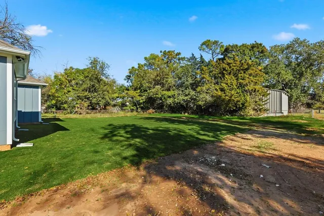 a front view of a house with a big yard