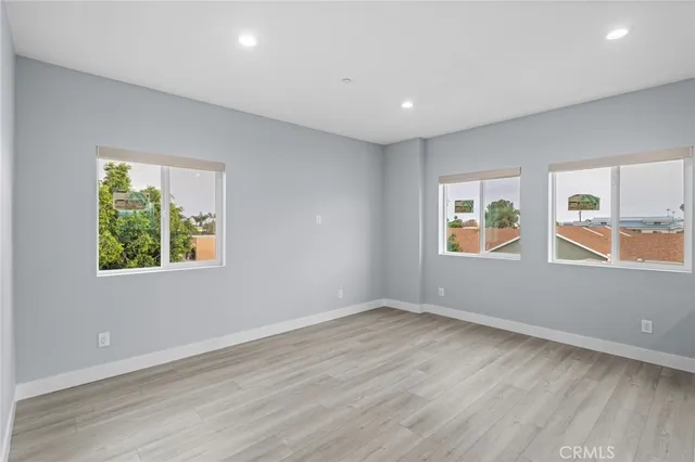 an empty room with closet and windows
