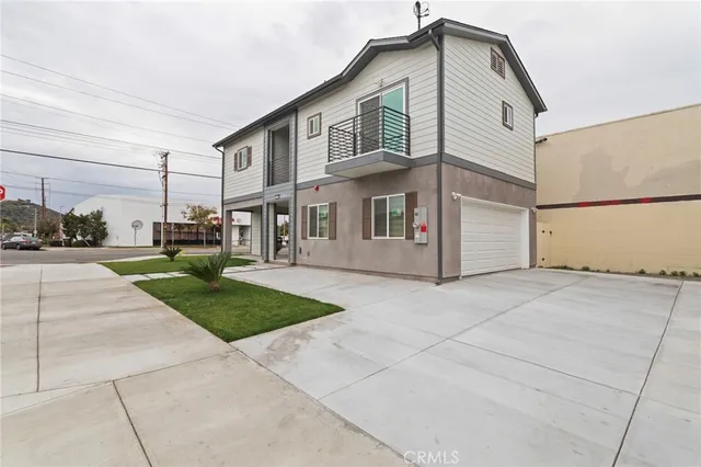 a kitchen with stainless steel appliances kitchen island wooden cabinets a stove a sink a refrigerator and a window