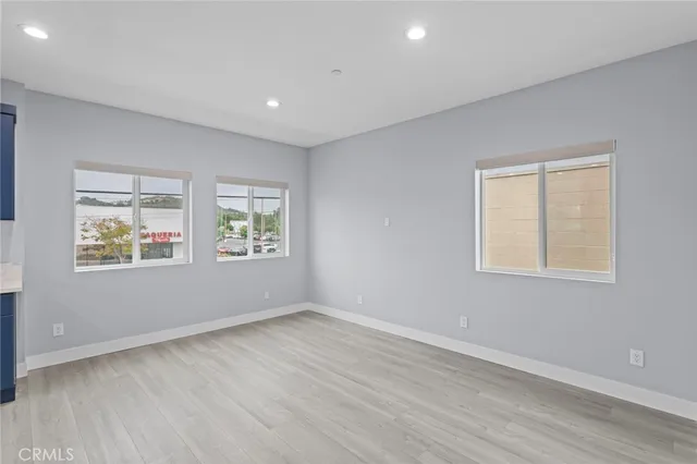 a large kitchen with stainless steel appliances granite countertop a large counter top a sink and a stove