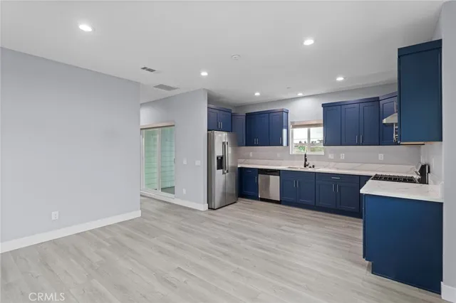 a kitchen with a sink a stove and cabinets
