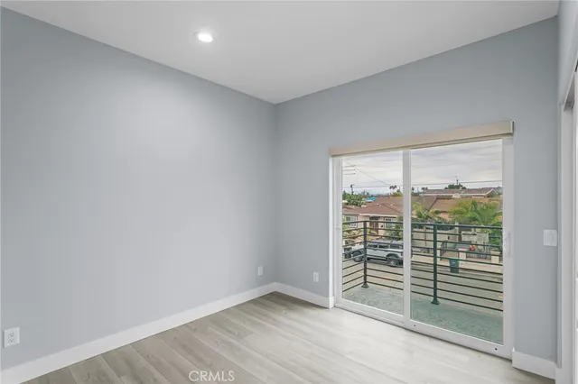 a view of walk in closet with wooden floor and a window
