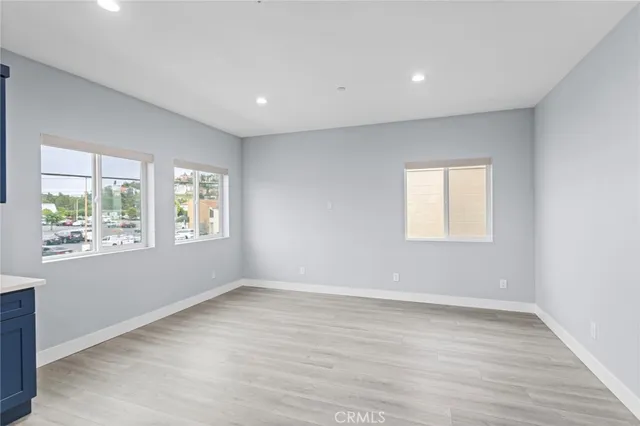 a bathroom with a toilet sink vanity granite and shower