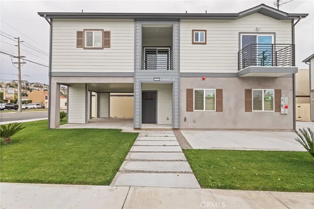 a aerial view of a house with a yard patio and lake view