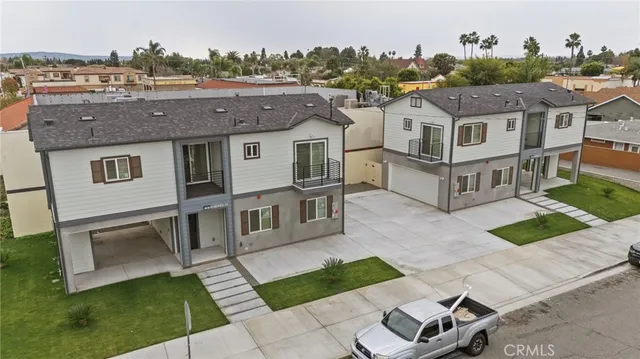 a front view of a house with a yard and garden