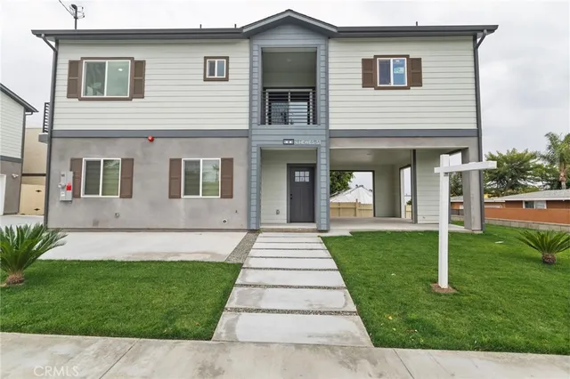 a large kitchen with stainless steel appliances granite countertop a large counter top a sink and dishwasher a wooden floor