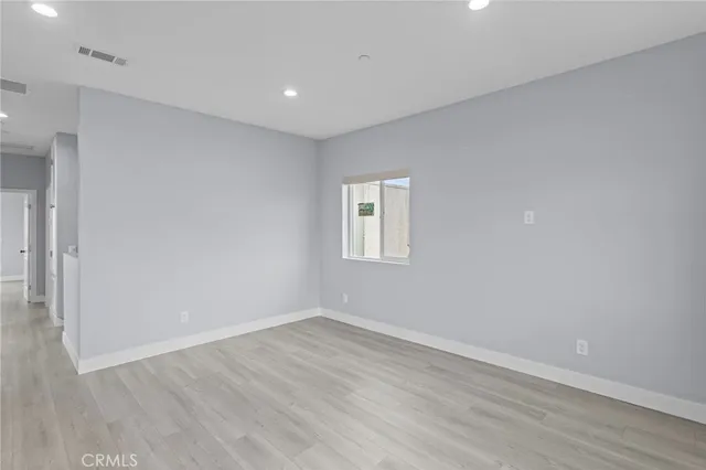 a kitchen with stainless steel appliances granite countertop a refrigerator a sink a stove a counter space and cabinets