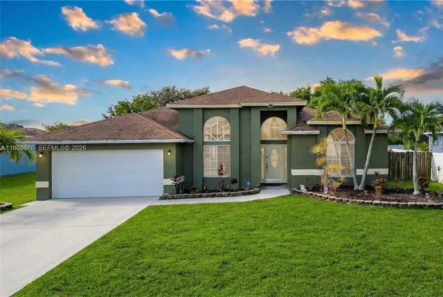 a front view of a house with a garden