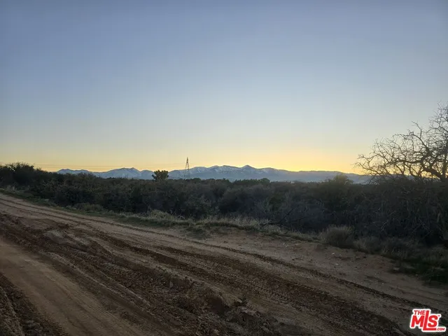 a view of a road with a field