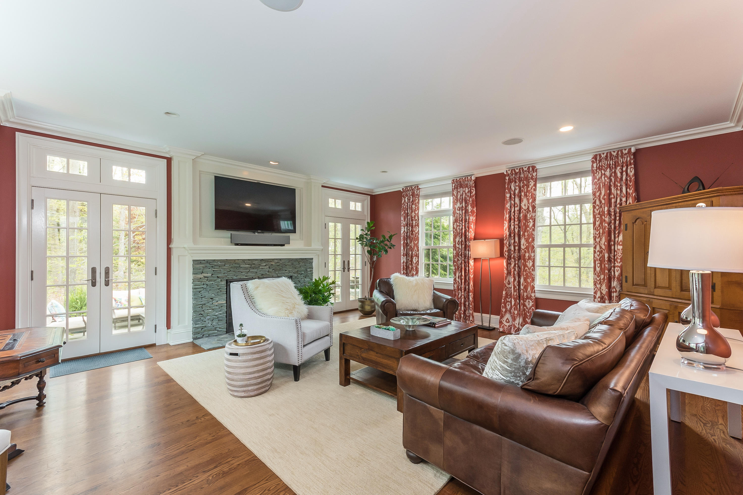 43 Stony Brook Road Darien, CT 06820 - Photo 12 of 46 a living room with furniture fireplace and a flat screen tv