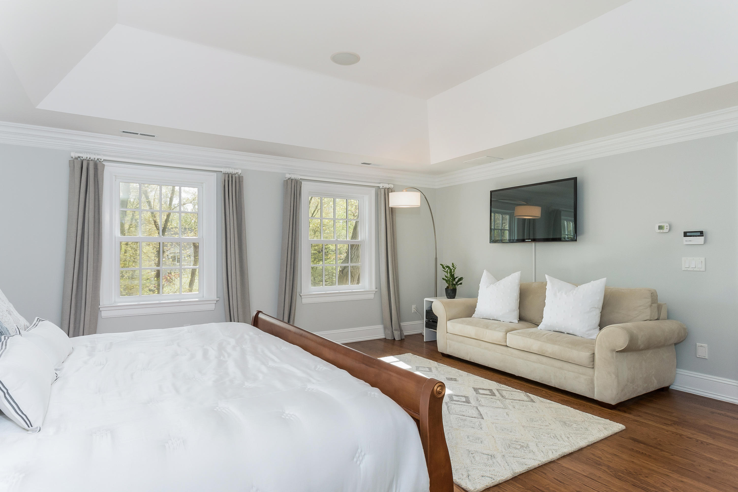 43 Stony Brook Road Darien, CT 06820 - Photo 18 of 46 a spacious bedroom with a bed and a couch
