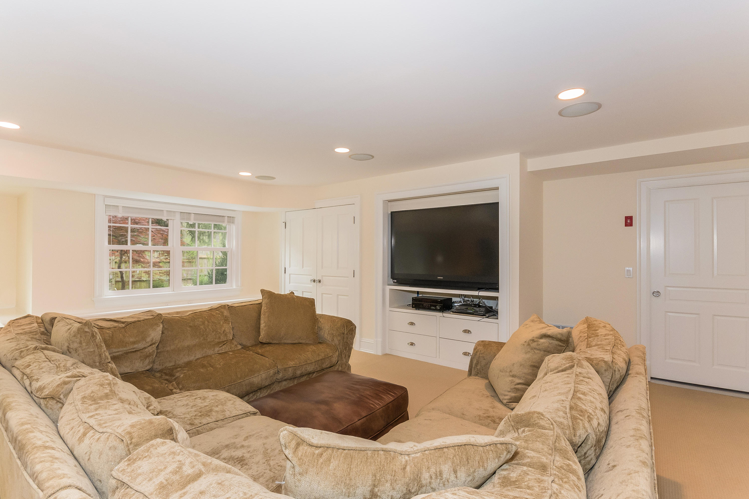 43 Stony Brook Road Darien, CT 06820 - Photo 31 of 46 a living room with furniture and a flat screen tv