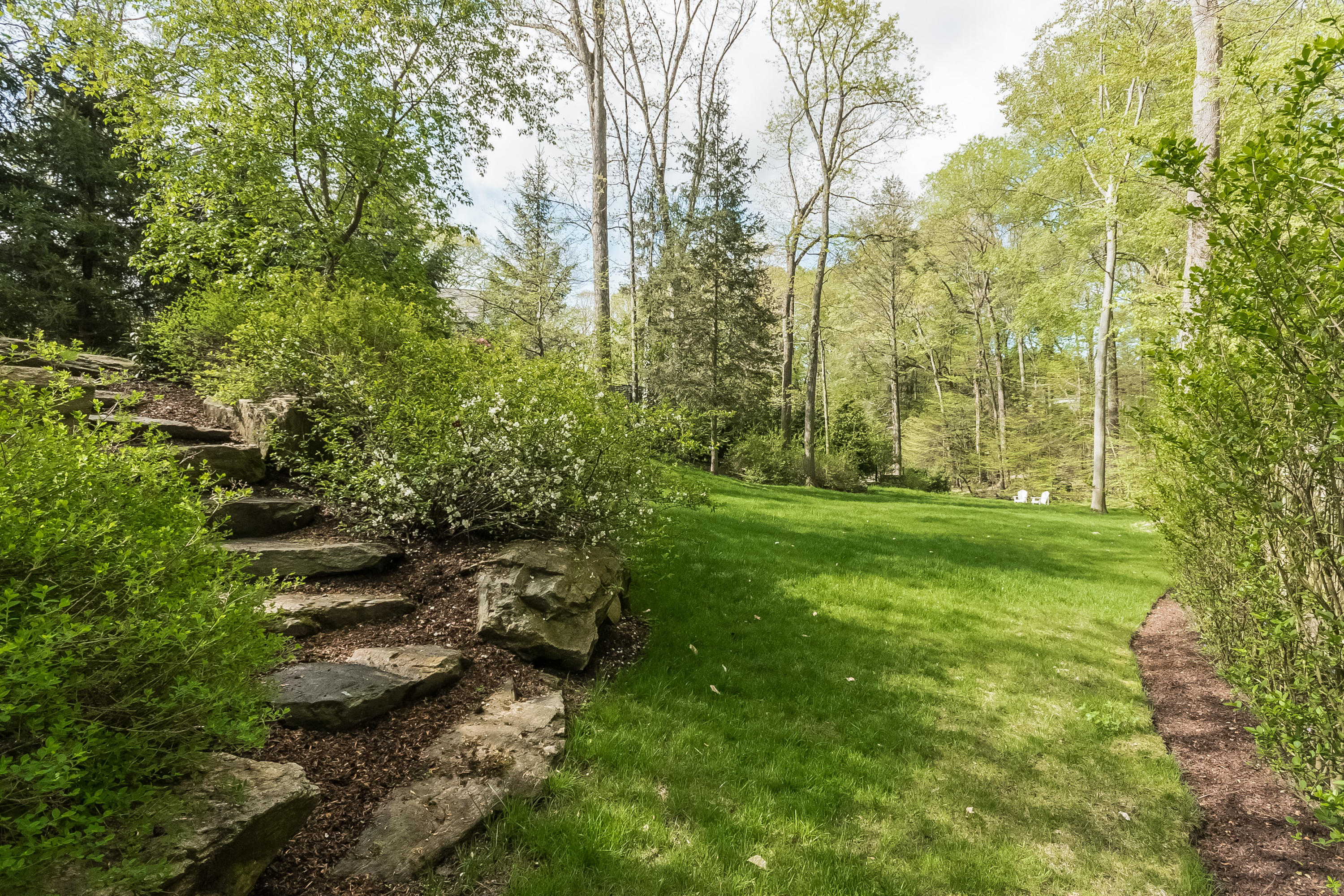 43 Stony Brook Road Darien, CT 06820 - Photo 37 of 46 a backyard of a house with lots of green space