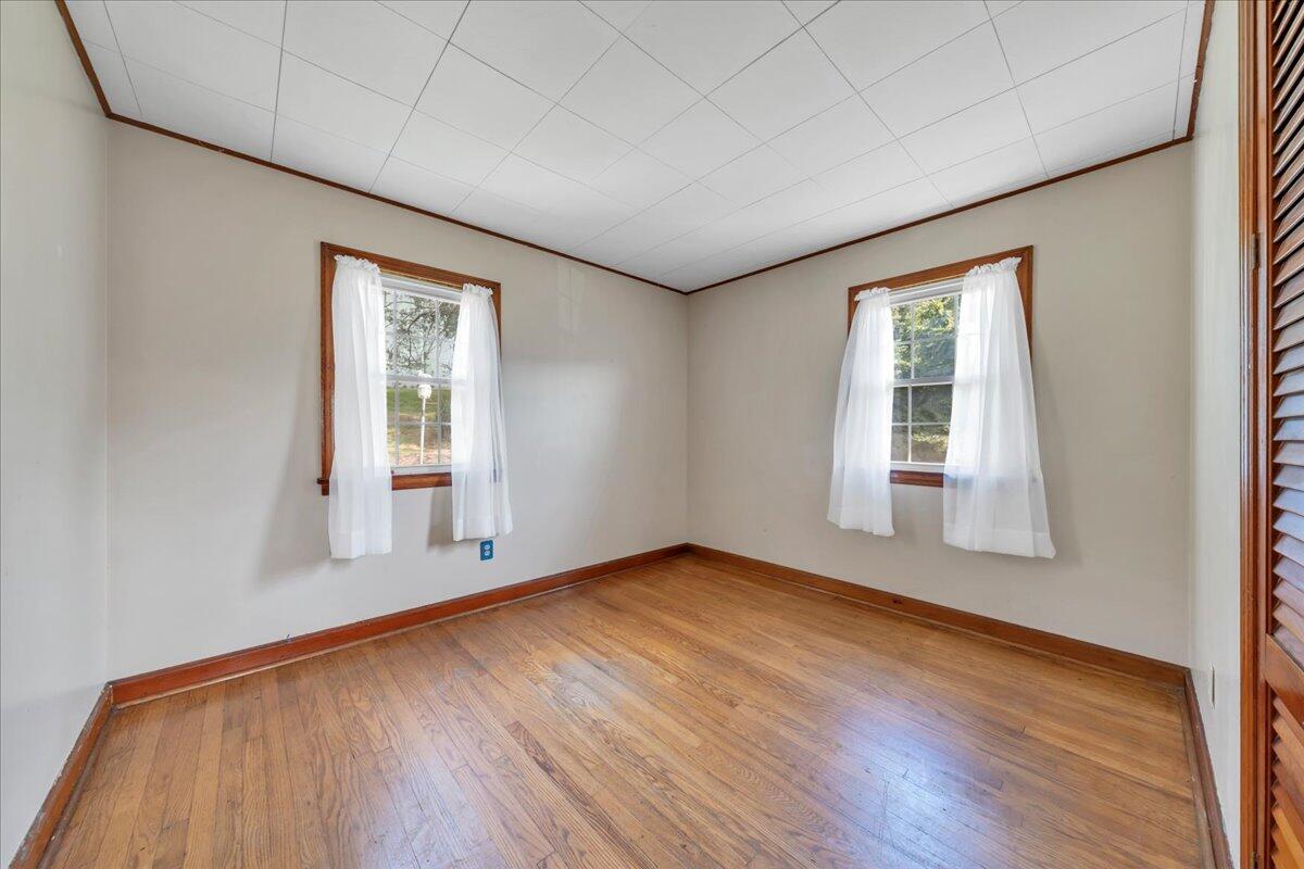 201 Long Avenue Covington, VA 24426 - Photo 16 of 43 an empty room with wooden floor and windows