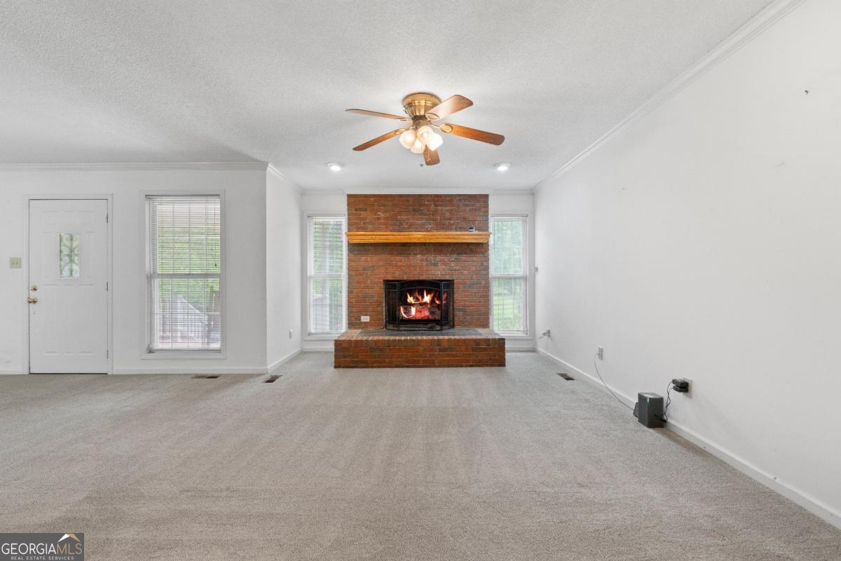 394 Hunter Road Griffin, GA 30224 - Photo 13 of 38 a view of an empty room with window and fireplace