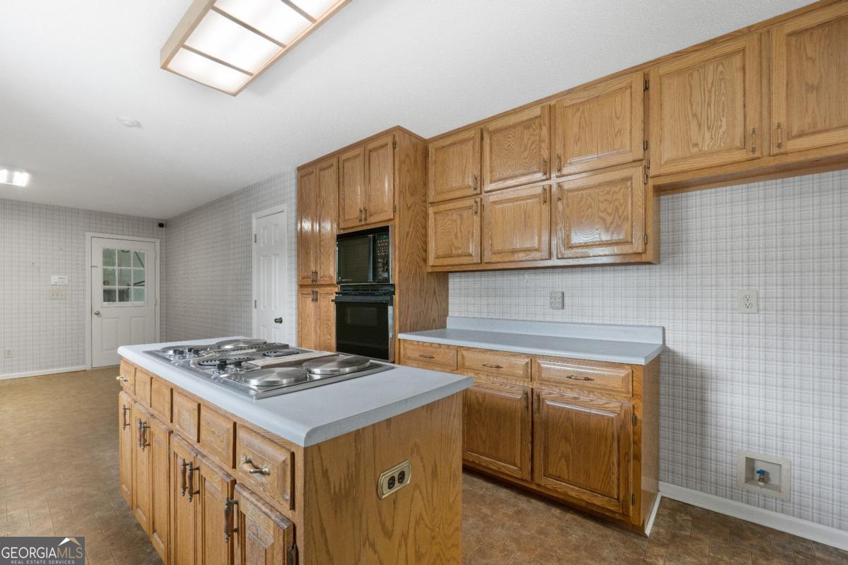 394 Hunter Road Griffin, GA 30224 - Photo 20 of 38 a kitchen with stainless steel appliances granite countertop a sink stove and refrigerator