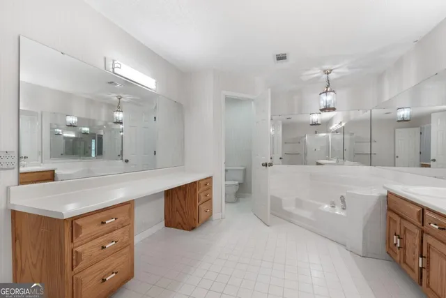 a bathroom with a sink a large mirror and shower