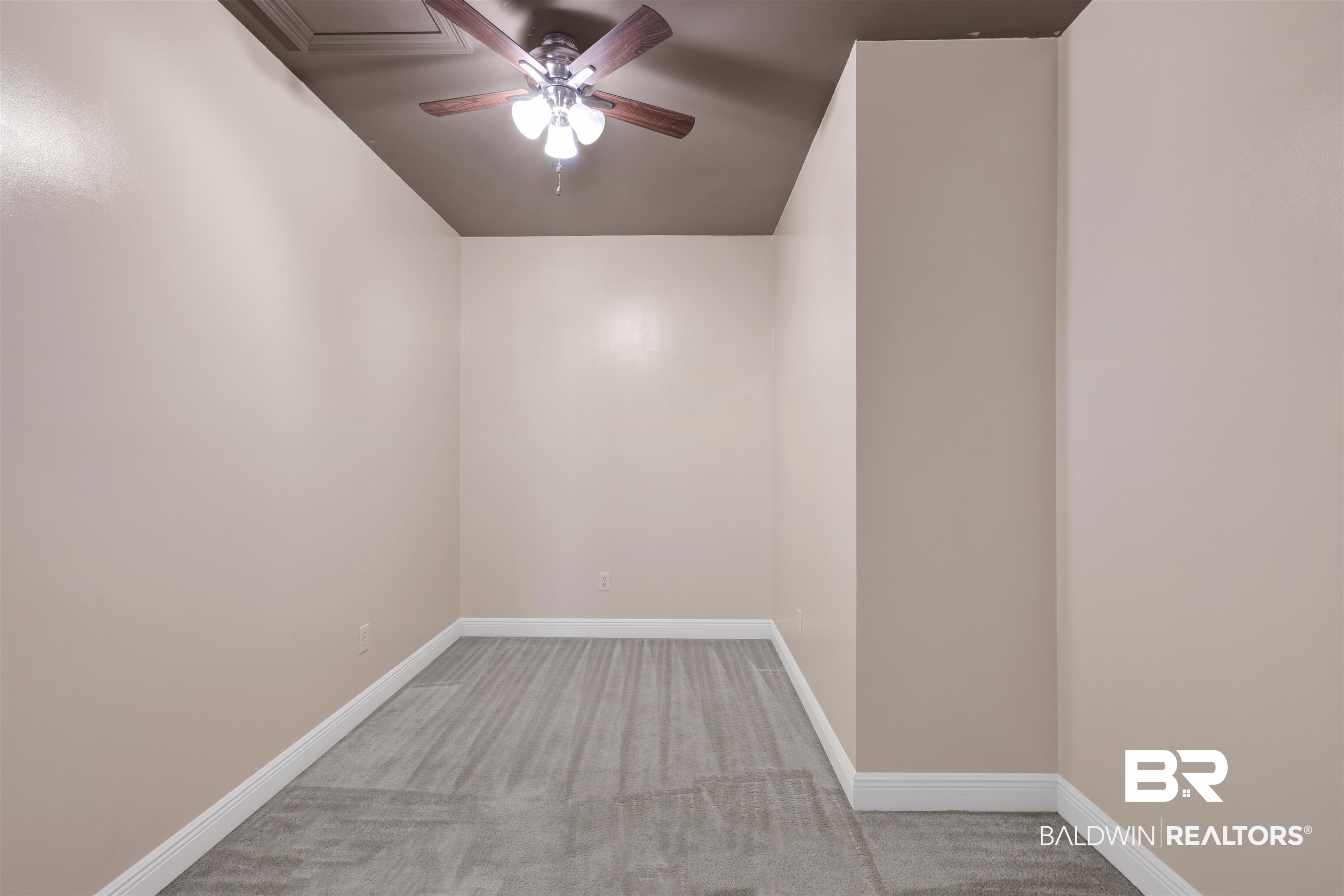 12944 Anna's Way Stapleton, AL 36578 - Photo 59 of 64 Room featuring a ceiling fan with light fixture, neutral wall paint, and gray wood-finish flooring