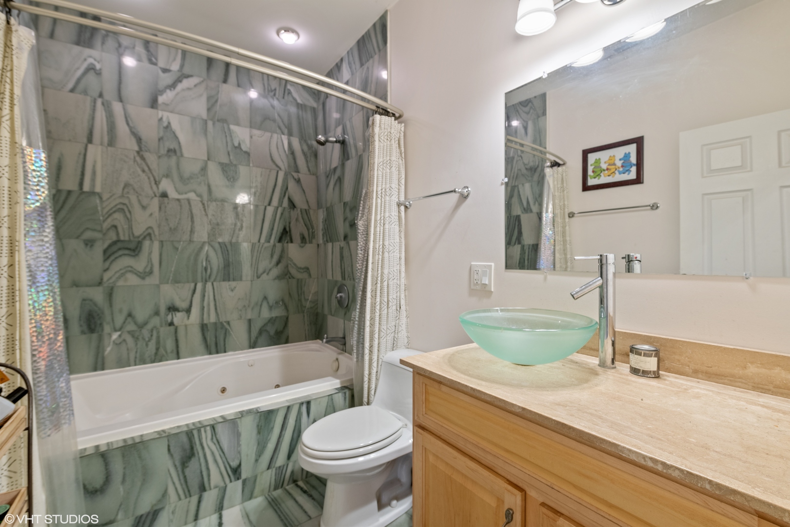 2108 North Spaulding Avenue, Unit 4 Chicago, IL 60647 - Photo 6 of 10 a bathroom with a granite countertop sink a toilet a mirror a bathtub and shower