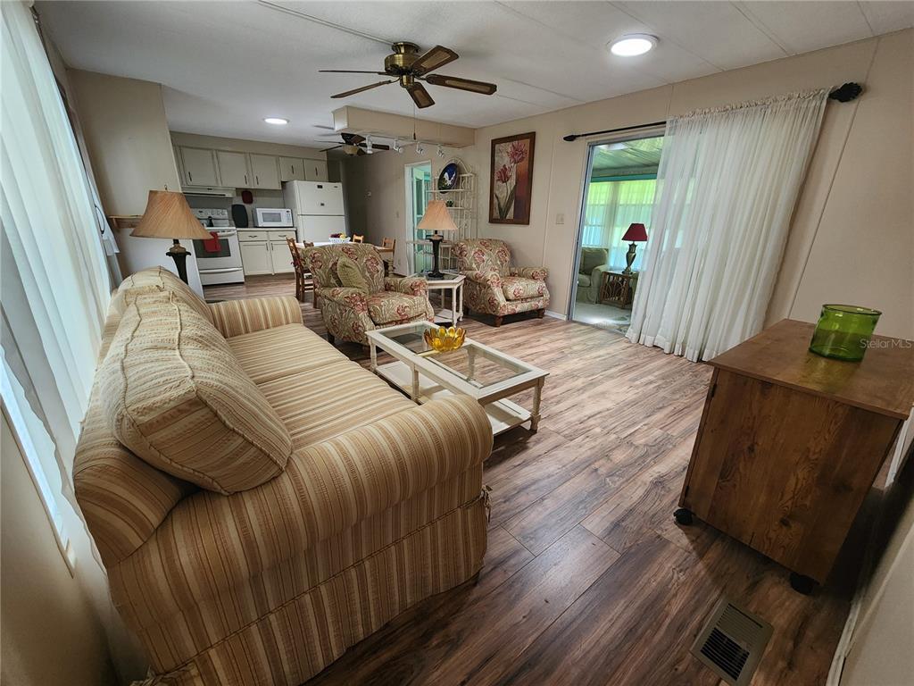 6400 Taylor/trout Road, Unit 96 Punta Gorda, FL 33950 - Photo 4 of 17 a living room with furniture and a wooden floor