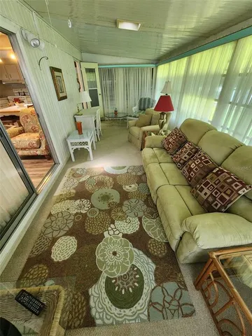 a view of a hallway with wooden floor and stairs