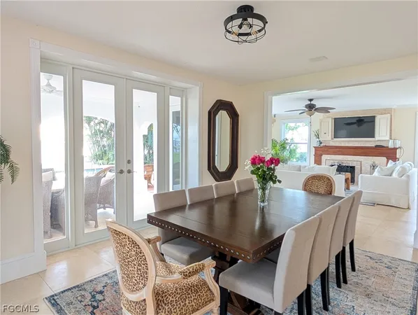 a living room with furniture a fireplace and a large window