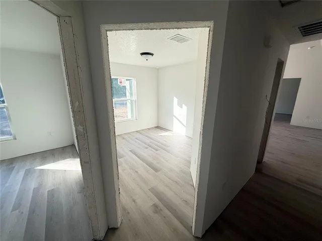 a spacious bathroom with a granite countertop sink and a shower