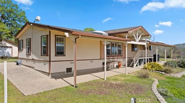 a view of a house with a yard and wooden fence