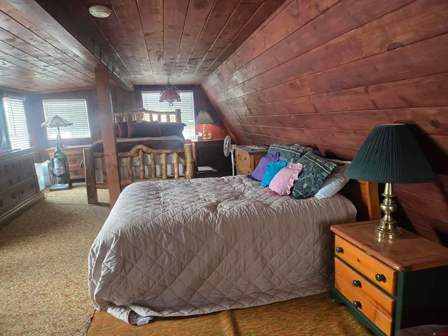 a view of an entryway with wooden floor and cabinet