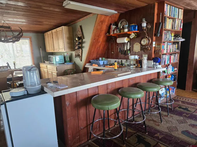 a dining room with furniture and a floor to ceiling window