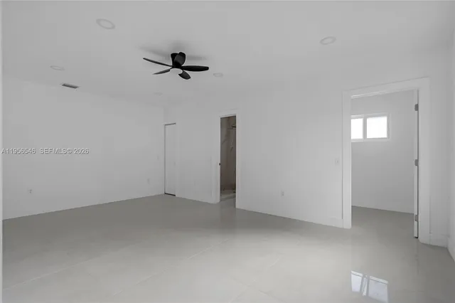 an empty room with a ceiling fan