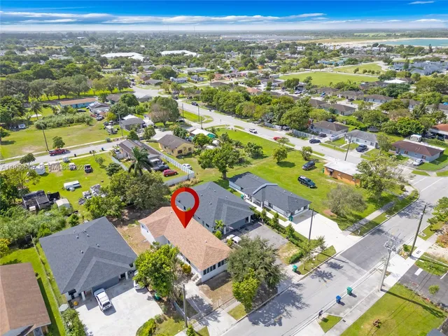 an aerial view of residential houses with outdoor space and street view
