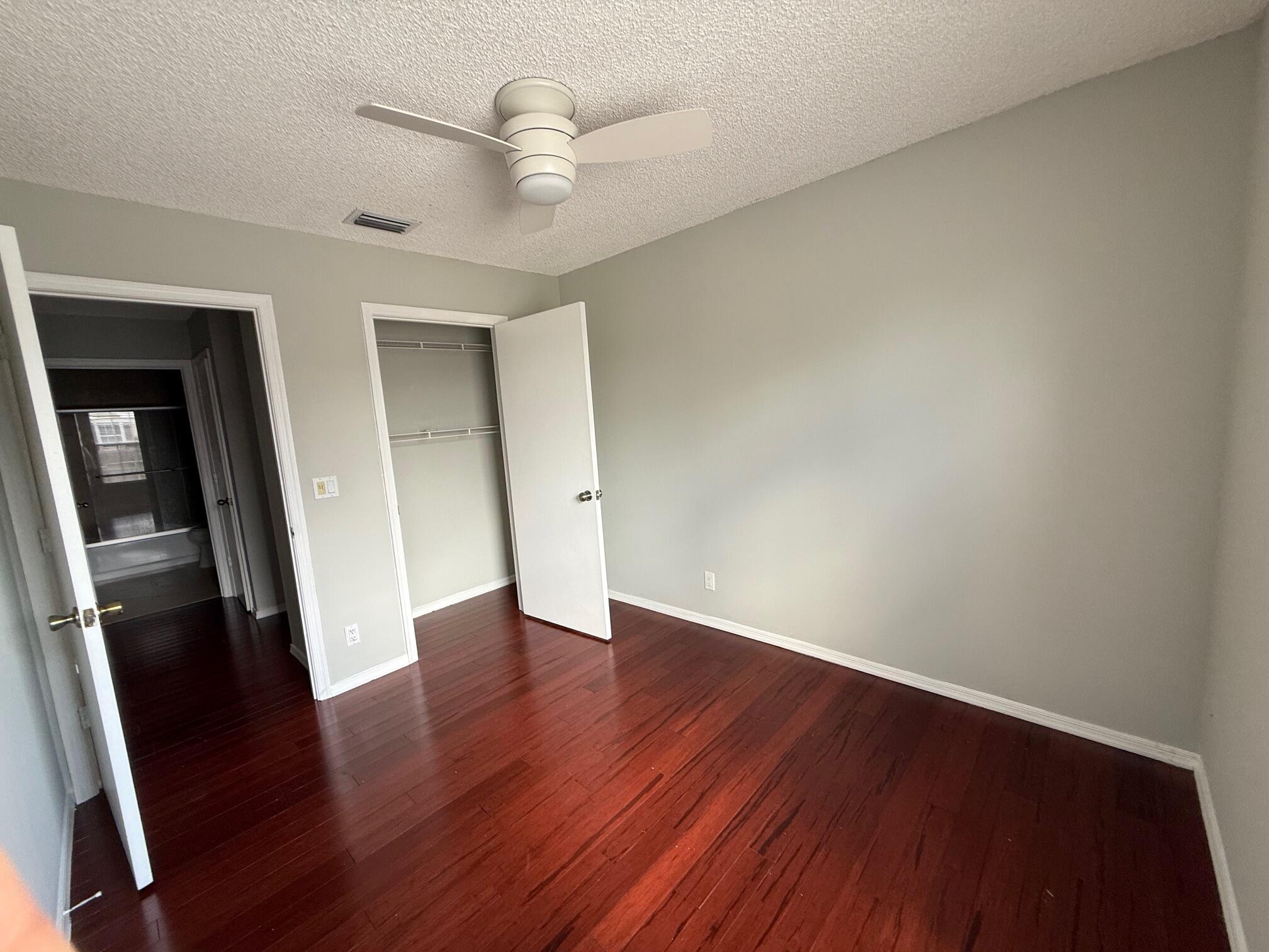 22492 Middletown Drive Boca Raton, FL 33428 - Photo 17 of 35 an empty room with wooden floor and ceiling fan