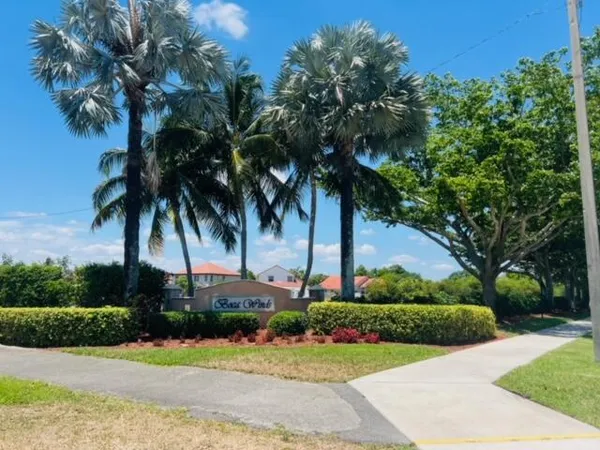 a front view of multi story residential apartment building with yard and green space