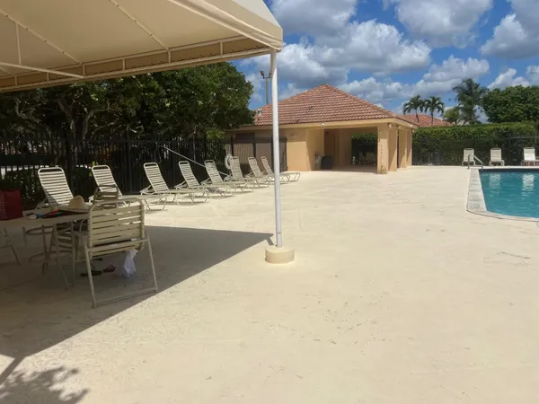 a view of a patio with table and chairs with wooden floor and fence