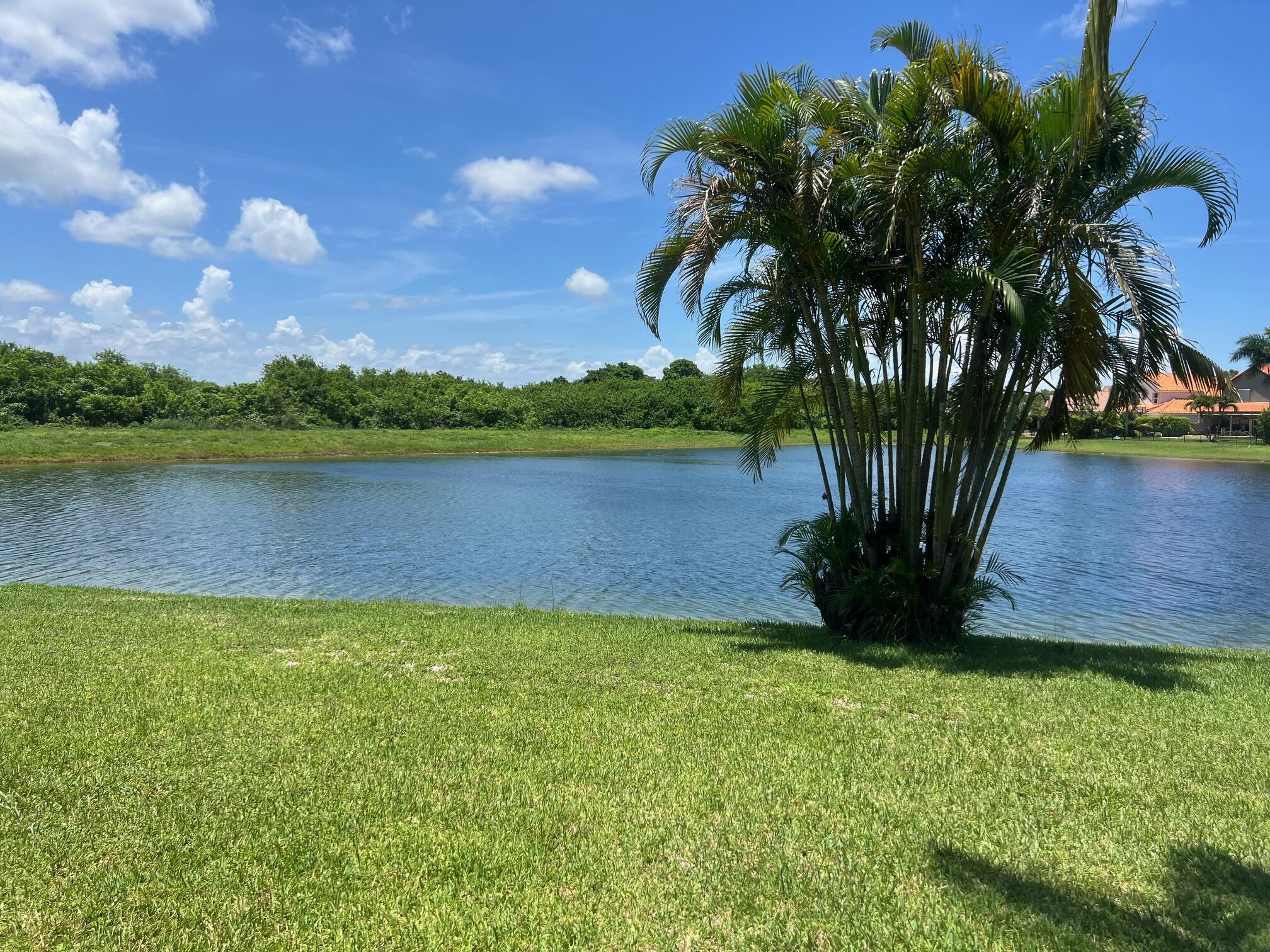 22492 Middletown Drive Boca Raton, FL 33428 - Photo 3 of 35 a view of a lake with a house in the background