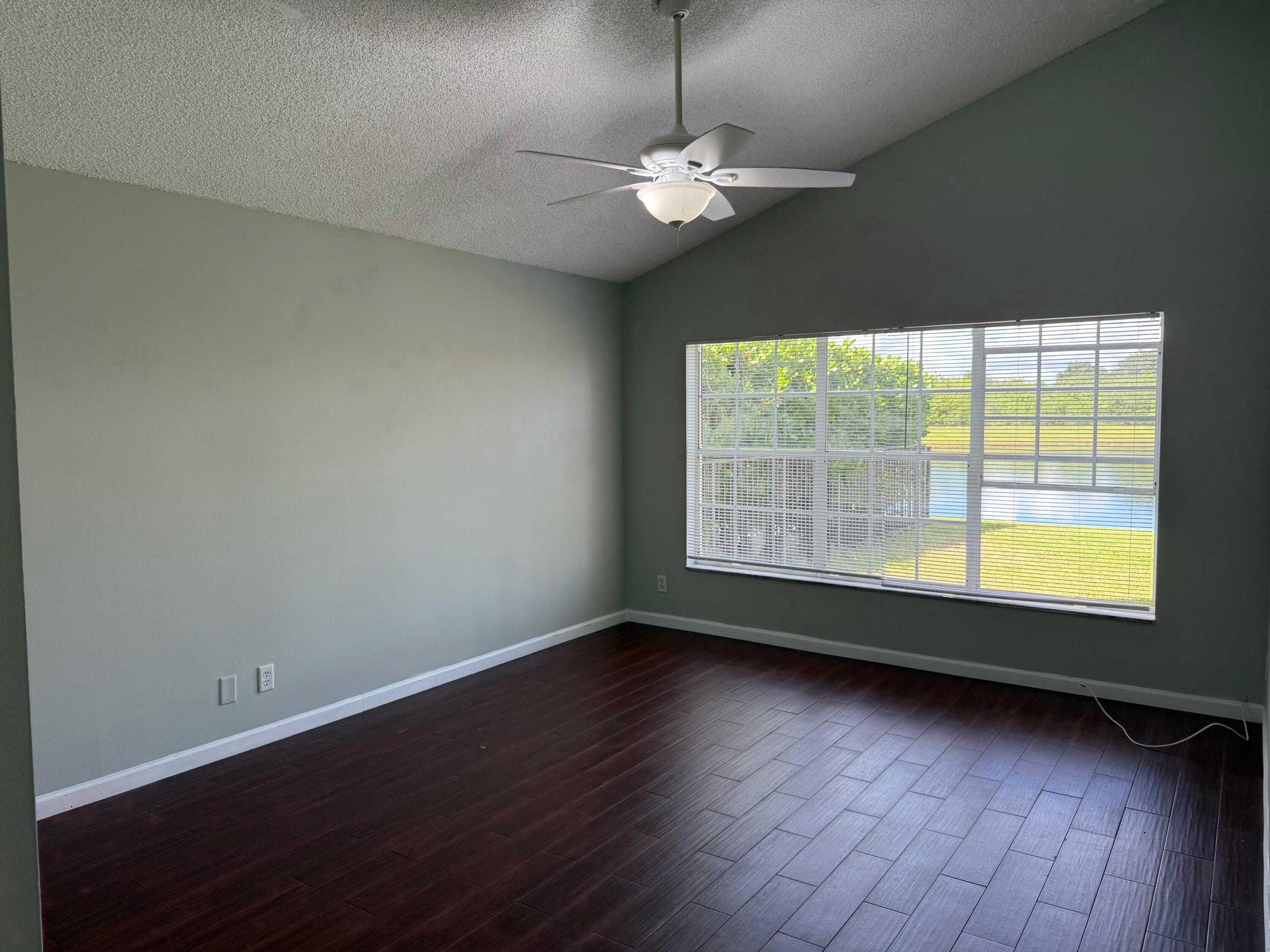 22492 Middletown Drive Boca Raton, FL 33428 - Photo 10 of 35 an empty room with wooden floor and windows