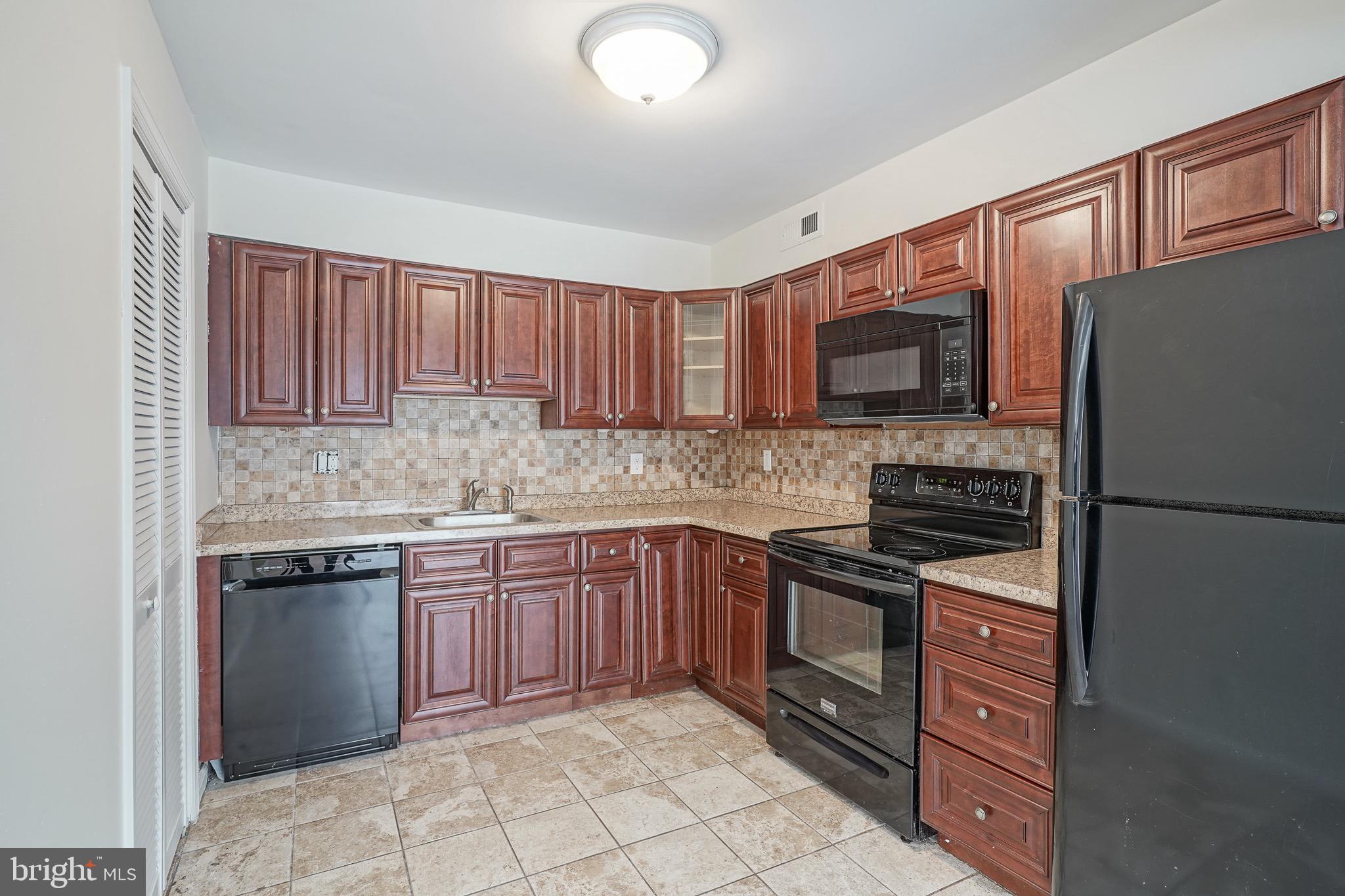 117 Chaucer Road Mount Laurel, NJ 08054 - Photo 9 of 20 a kitchen with stainless steel appliances granite countertop a stove top oven a sink and dishwasher