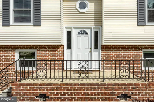 a view of a livingroom with wooden floor and a large window