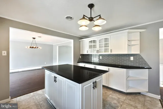 a bathroom with a bathtub a mirror a sink and vanity