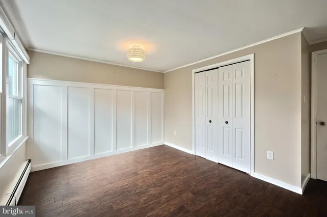 a view of room with window and wooden floor
