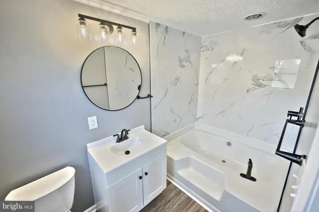 an empty room with windows and fireplace