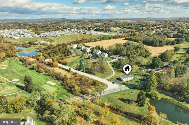 an aerial view of residential houses with outdoor space