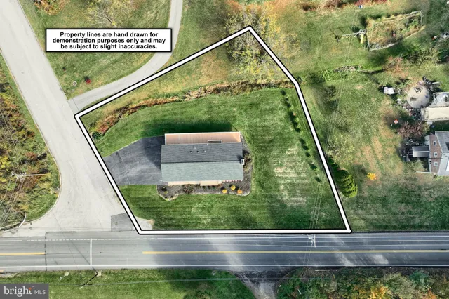 an aerial view of a house with a yard