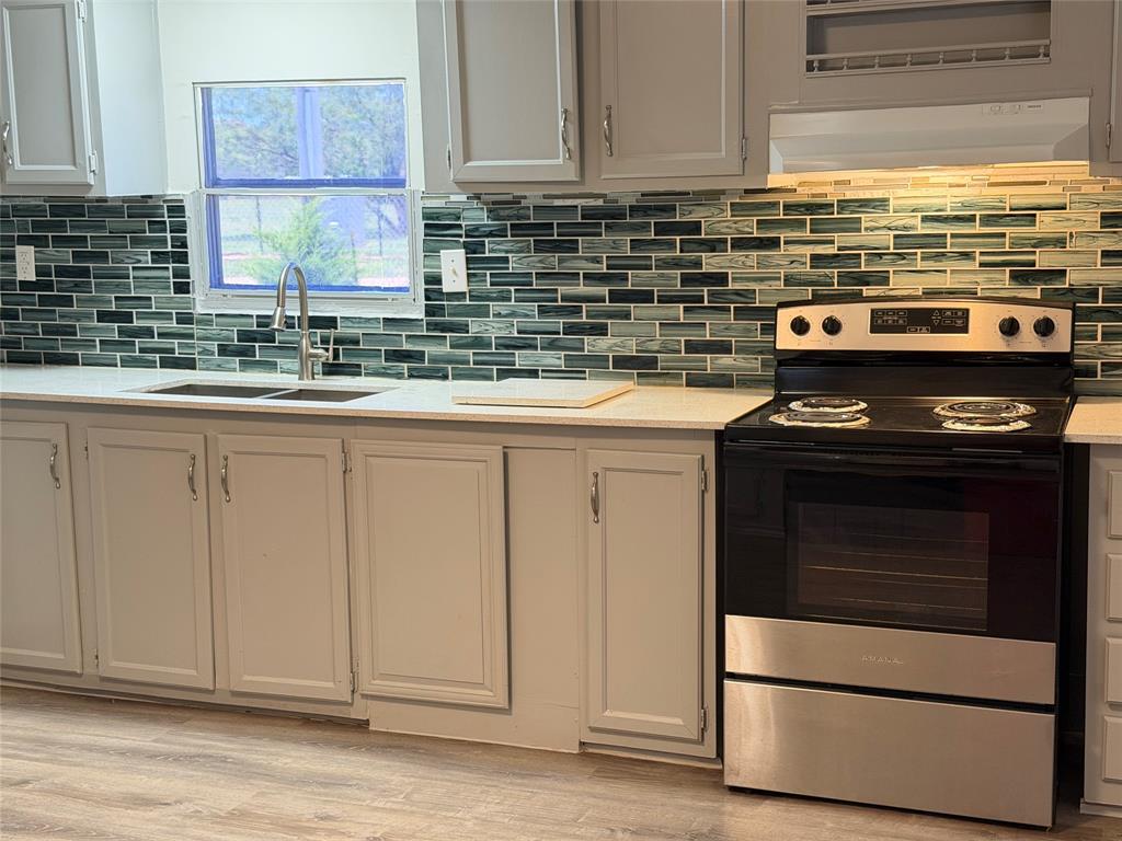 222 Hix Road Cleburne, TX 76031 - Photo 6 of 27 a kitchen with granite countertop cabinets stainless steel appliances and a sink