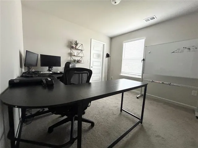 a view of a workspace with furniture