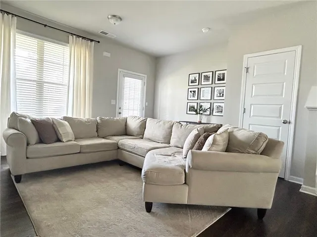 a living room with furniture and a large window