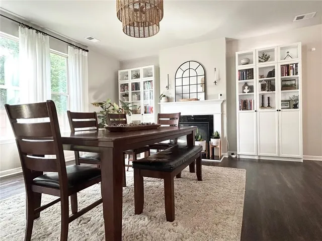 a dining room with furniture a chandelier and wooden floor